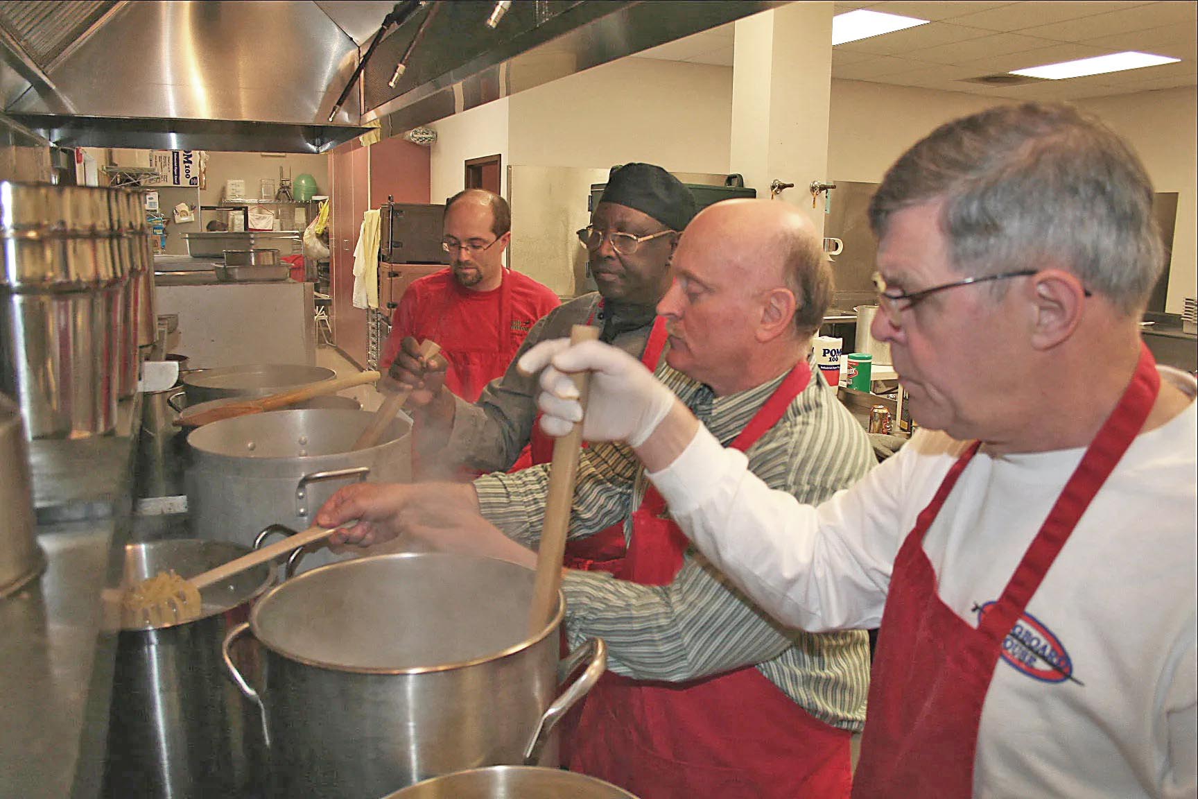 Men cooking. Bethlehem Area Moravian Freezer Ministry grant recipient.